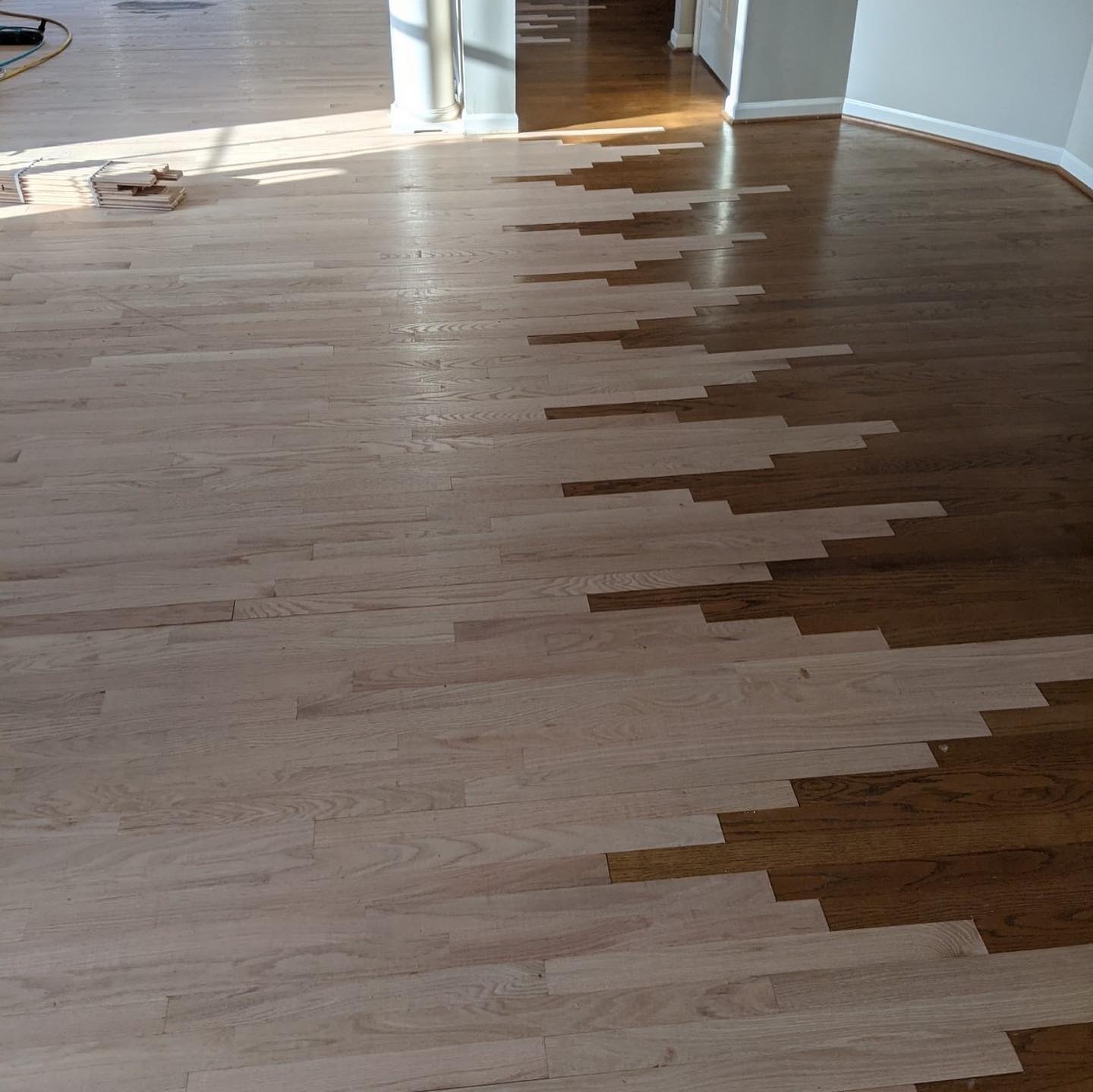 Hardwood flooring being threaded in to old flooring